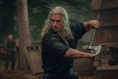 Geralt of Rivia dual-wielding a sword and axe