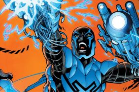 Blue Beetle firing his arm cannons.