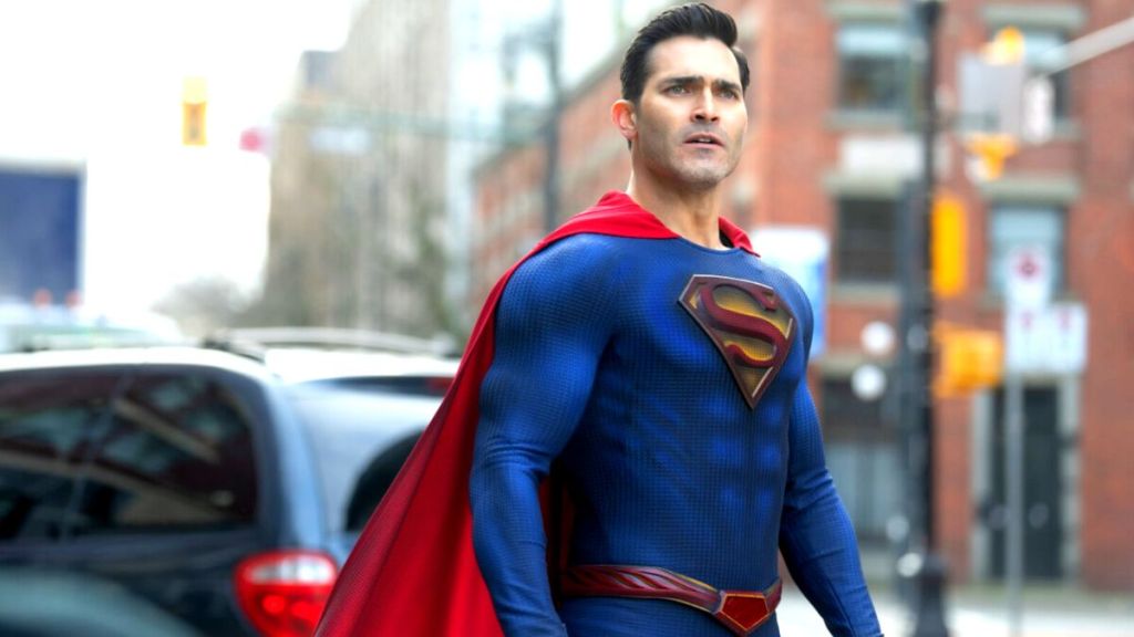 Superman standing in the street with his cape billowing.