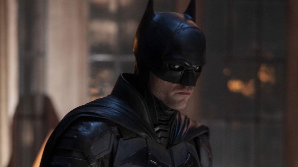 Batman looks to his right and stares.