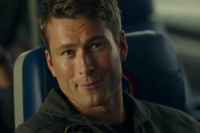 Glen Powell stares and smirks in Top Gun Maverick.