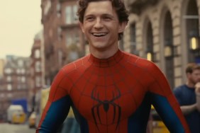 Tom Holland stands and smiles.