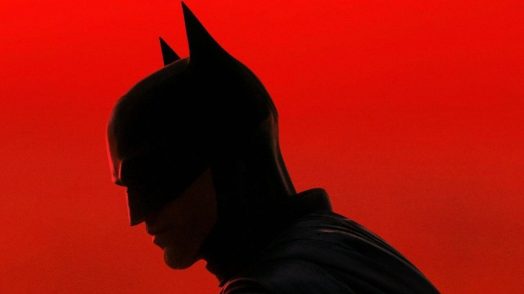 Batman stands with his mask on.