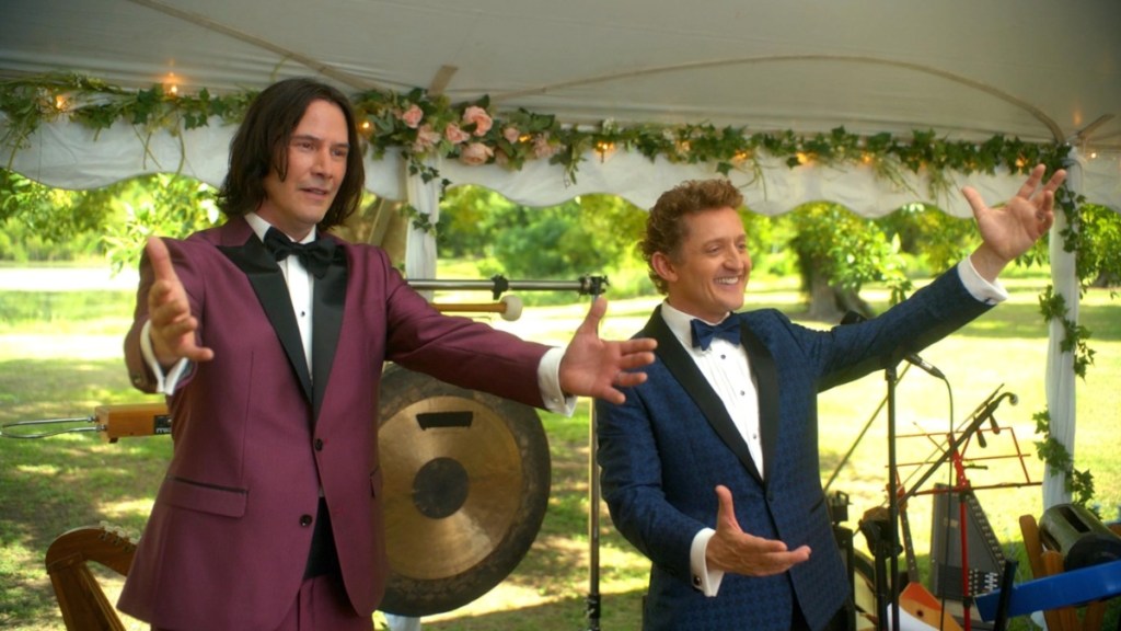 Kenau Reeves and Alex Winter put their hands up.