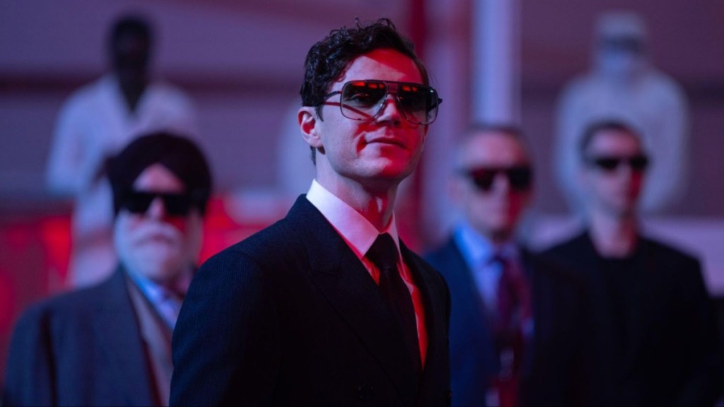 Evan Peters smirks and stares.