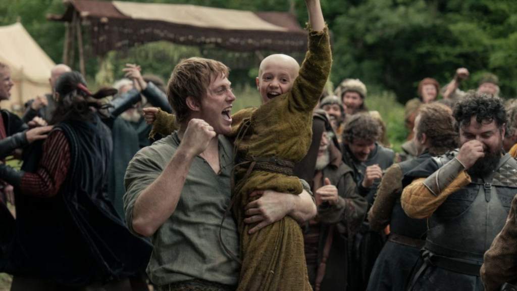 A man holds a little boy in A Knight of the Seven Kingdoms.
