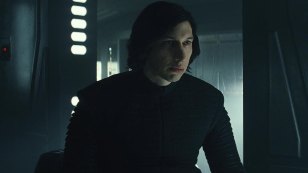 Adam Driver sits and stares as Kylo Ren.