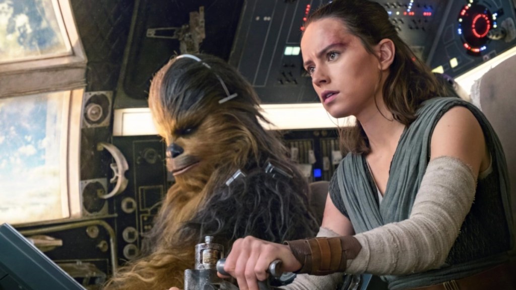 Rey sits with Chewbacca in The Last Jedi.