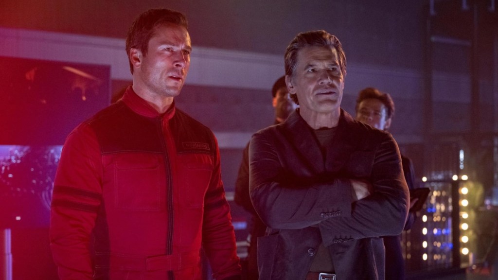 Two men stand next to each other in The Running Man.