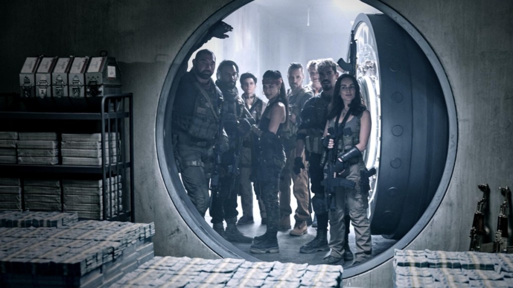 A group of mercenaries stand outside a vault in Army of the Dead.