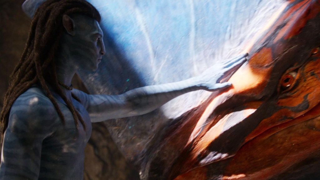 Jake Sully pets an animal in Avatar: Fire and Ash.