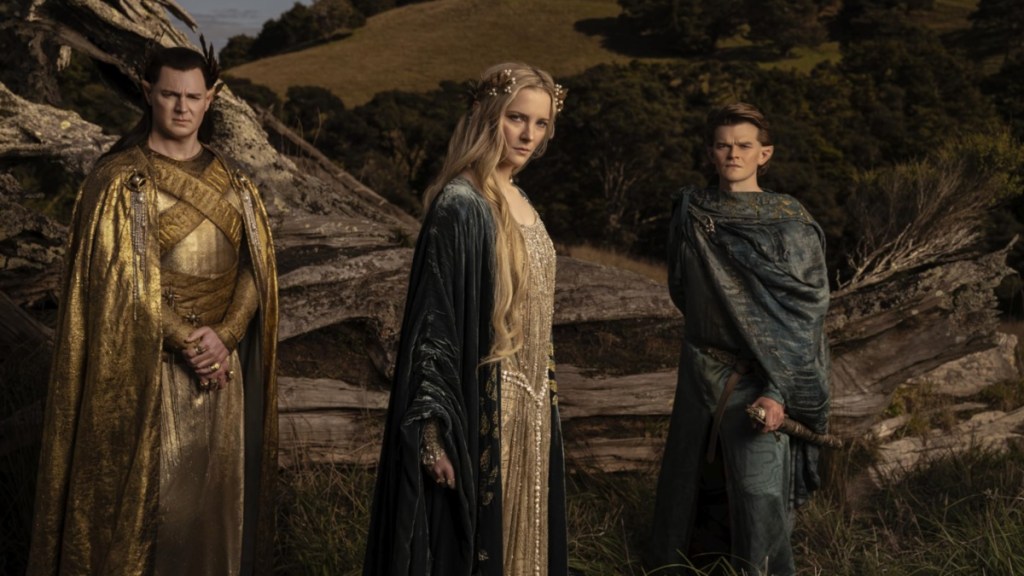 Three characters in The Rings of Power stand and look.
