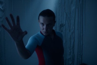 Millie Bobby Brown sticks hand out on Stranger Things.