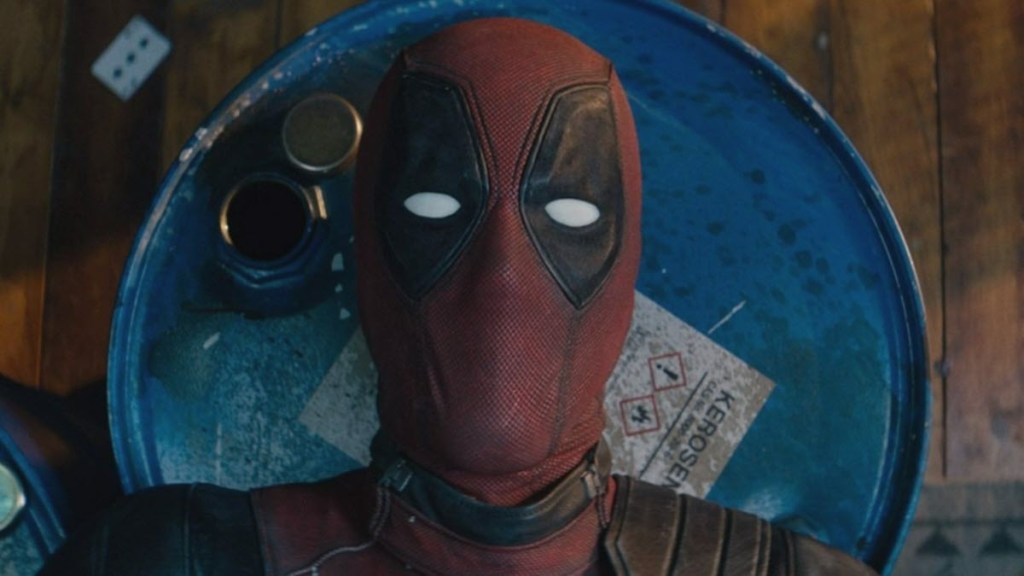 Deadpool laying on explosive barrels in Deadpool 2 opening scene