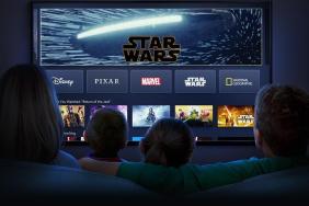 A family looks at a TV.