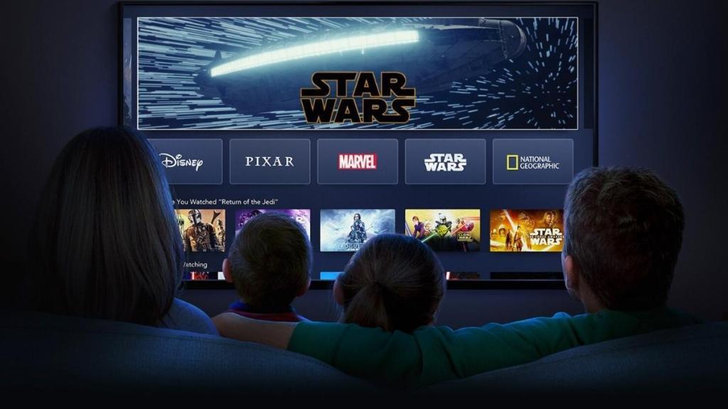 A family looks at a TV.