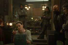 Rebecca Ferguson sits around a table in Silo.