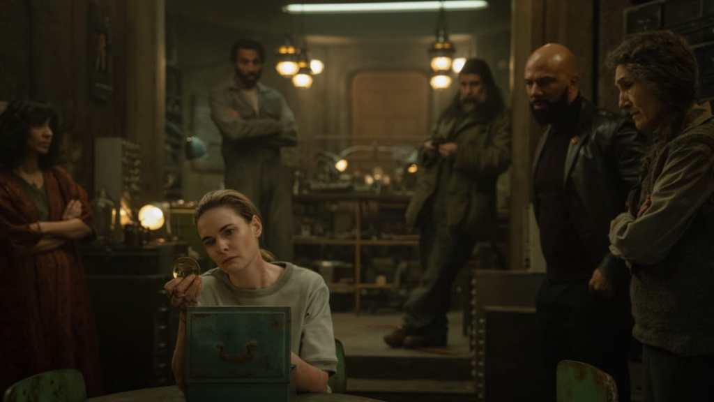 Rebecca Ferguson sits around a table in Silo.