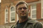 Alan Ritchson stares as Reacher.