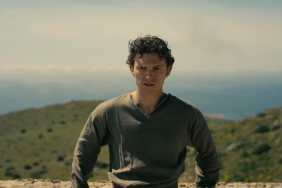Tom Holland leans against a rock in The Odyssey.