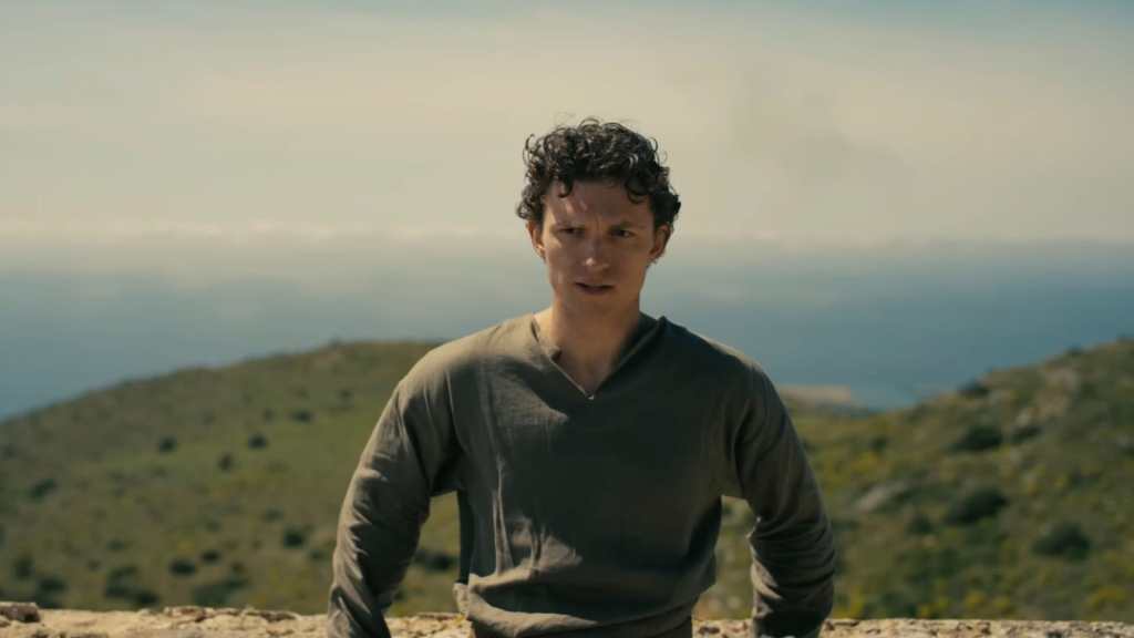 Tom Holland leans against a rock in The Odyssey.