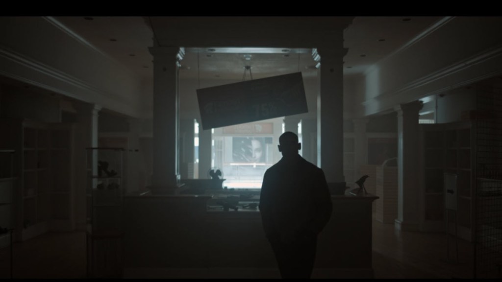 Janus Cosmetics Sign Face in background in Lanterns Episode 3 OutKast