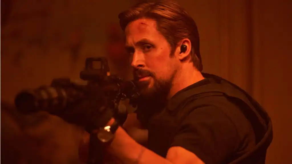 Ryan Gosling points gun and shoots in The Gray Man.