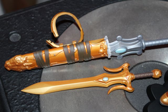 Filmation sword in sheath, He-Man-style sword beside