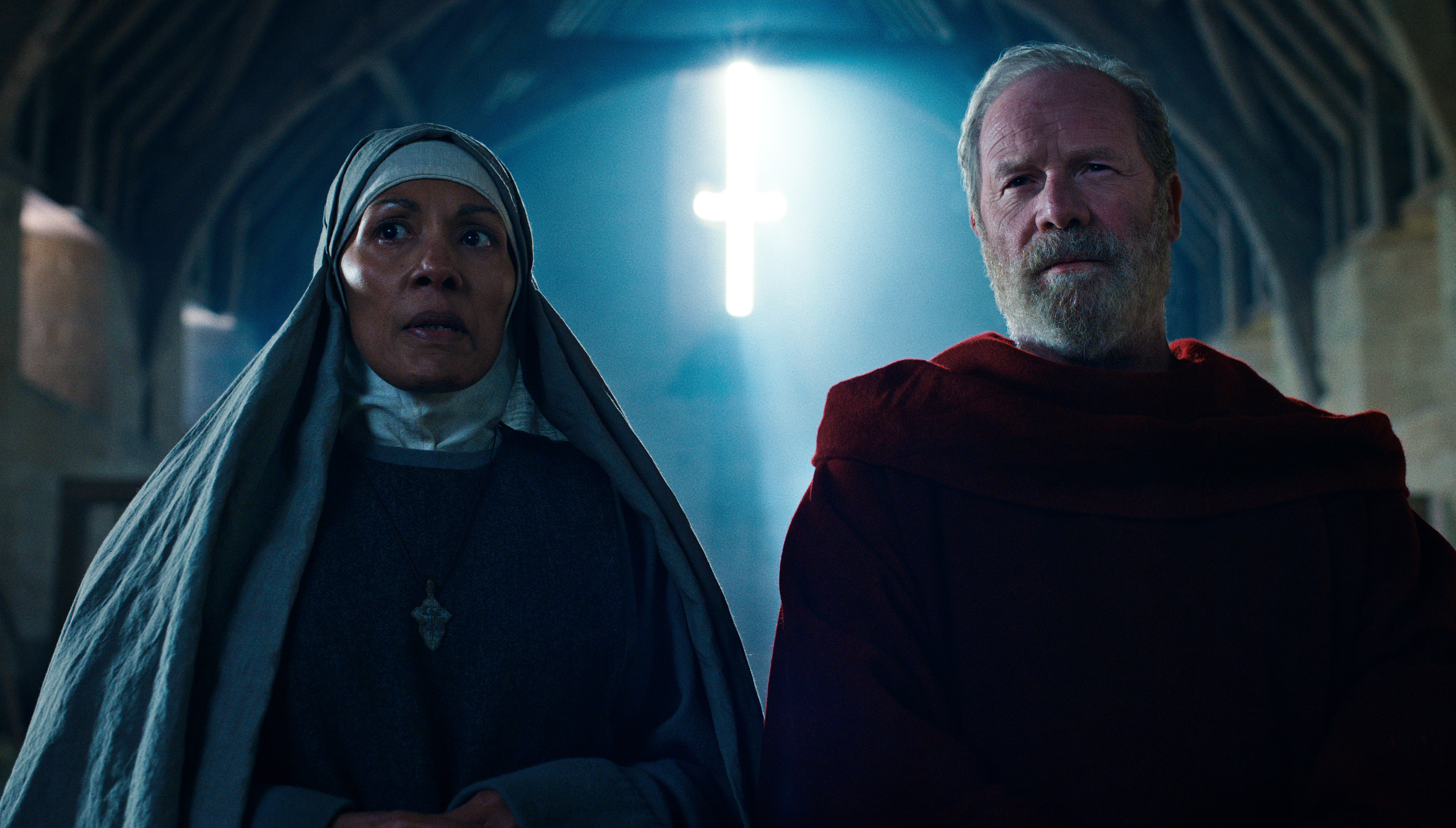 CAROLINE LEE JOHNSON as ABBESS NORA and PETER MULLAN as FATHER CARDEN